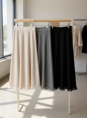Ribbed Knit Maxi Skirt — A soft ribbed knit maxi with a wide elastic waist. Waist 26–36 inches, length 31 inches. Cream 