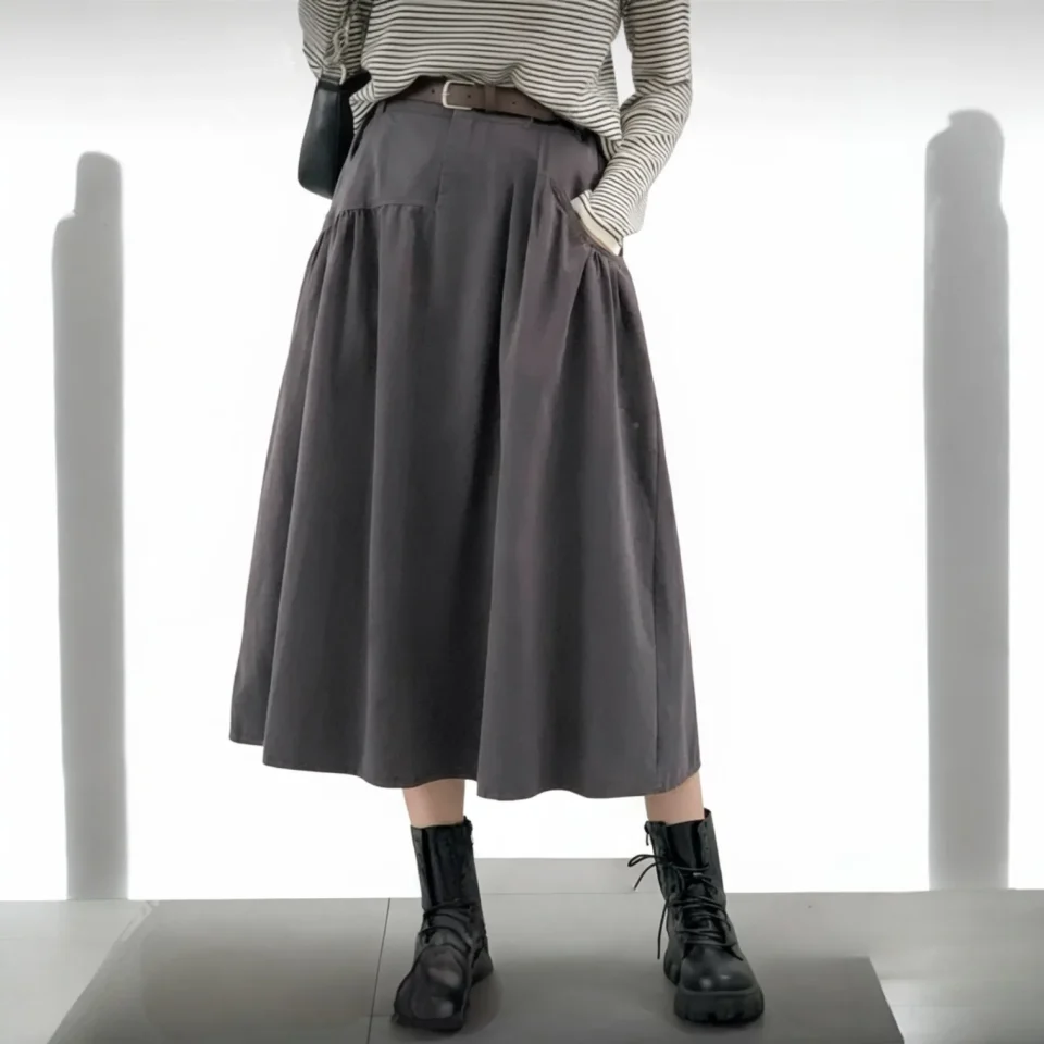 Everyday A-Line Midi Skirt — A yoked A-line midi with deep angled pockets and a matching belt. Waist 24–36 inches, lengt