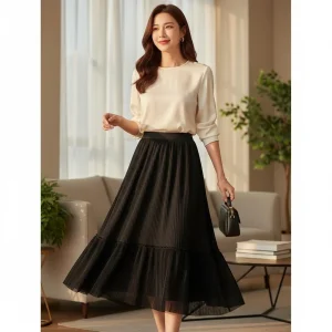 Midnight Cascades Pleated Midi Skirt — A black A-line midi with finely pleated tiers and a semi-sheer hem. Fully lined, 