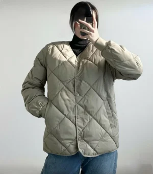 Quilted Liner Jacket — A light diamond-quilted jacket that layers under a coat or stands on its own. Cream or sage. Butt