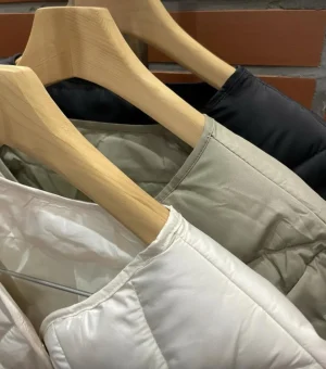 Quilted Liner Jacket — A light diamond-quilted jacket that layers under a coat or stands on its own. Cream or sage. Butt