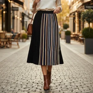 Artisan Pleat Colour-Block Midi Skirt — A pleated midi in black with an asymmetric panel of cream and tan stripes runnin