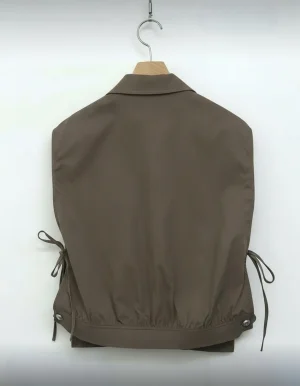 Cropped Utility Tie-Side Vest — A cropped sleeveless shirt-jacket in washed olive, with chest pockets and lace-up ties a