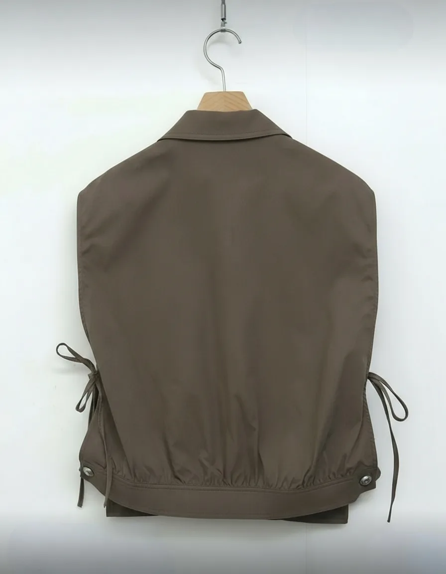 Cropped Utility Tie-Side Vest — A cropped sleeveless shirt-jacket in washed olive, with chest pockets and lace-up ties a