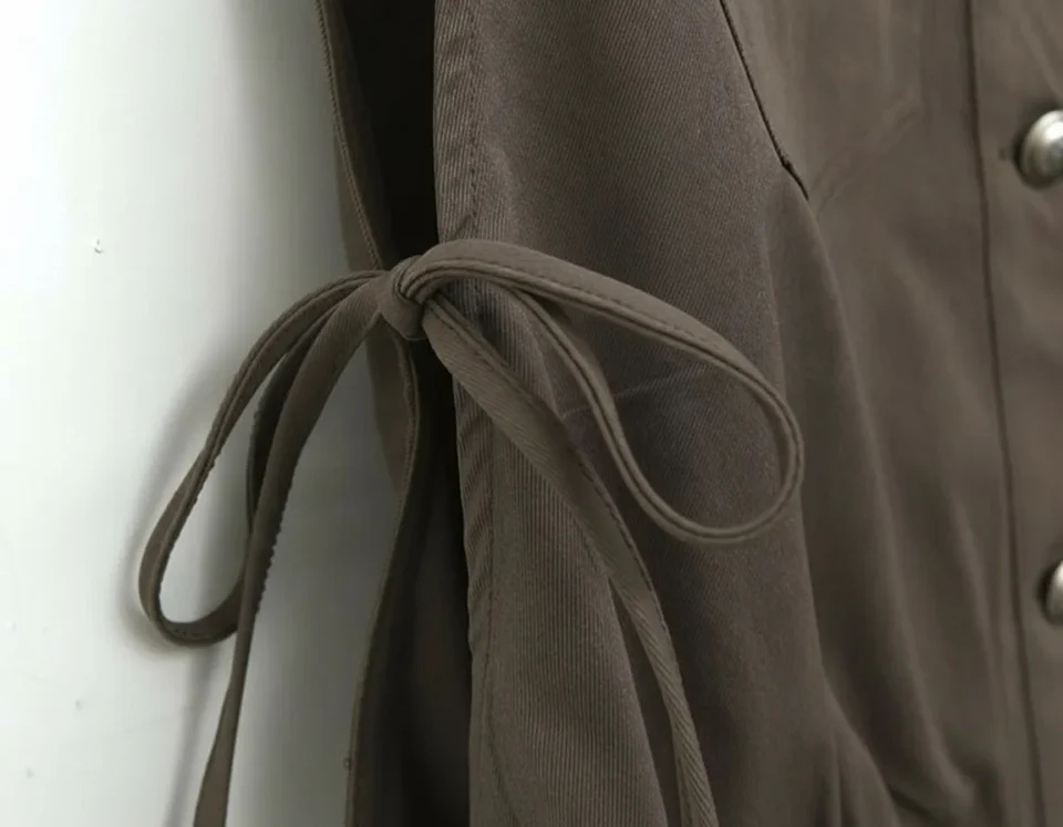 Cropped Utility Tie-Side Vest — A cropped sleeveless shirt-jacket in washed olive, with chest pockets and lace-up ties a