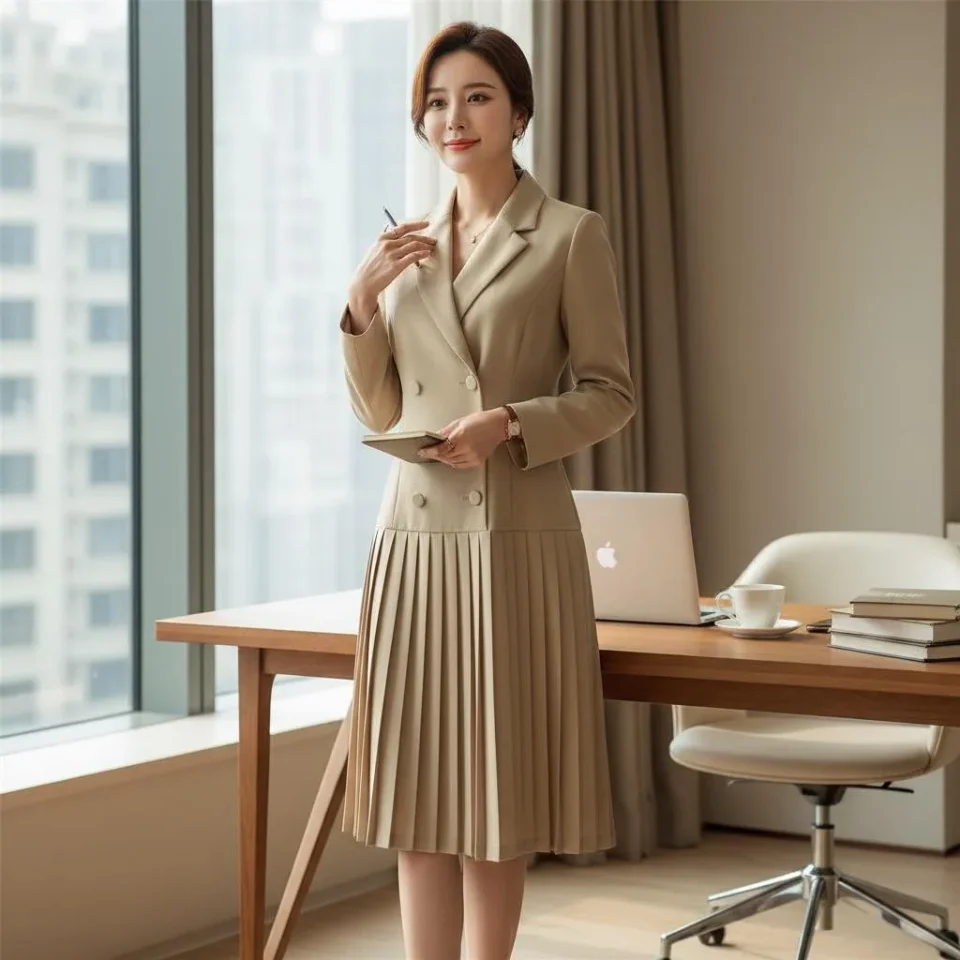Executive Pleat Trench Dress — A taupe double-breasted blazer top running into a knife-pleated skirt. Wearable as a dres