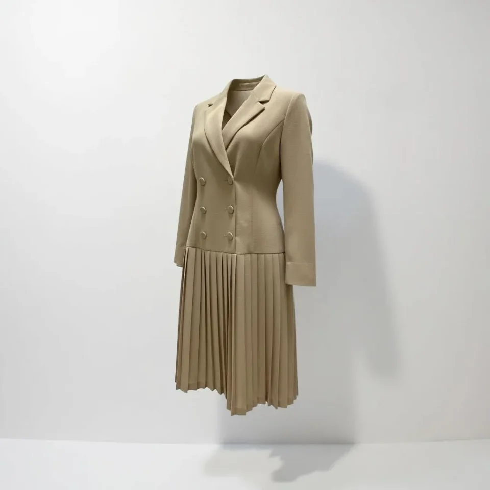 Executive Pleat Trench Dress — A taupe double-breasted blazer top running into a knife-pleated skirt. Wearable as a dres