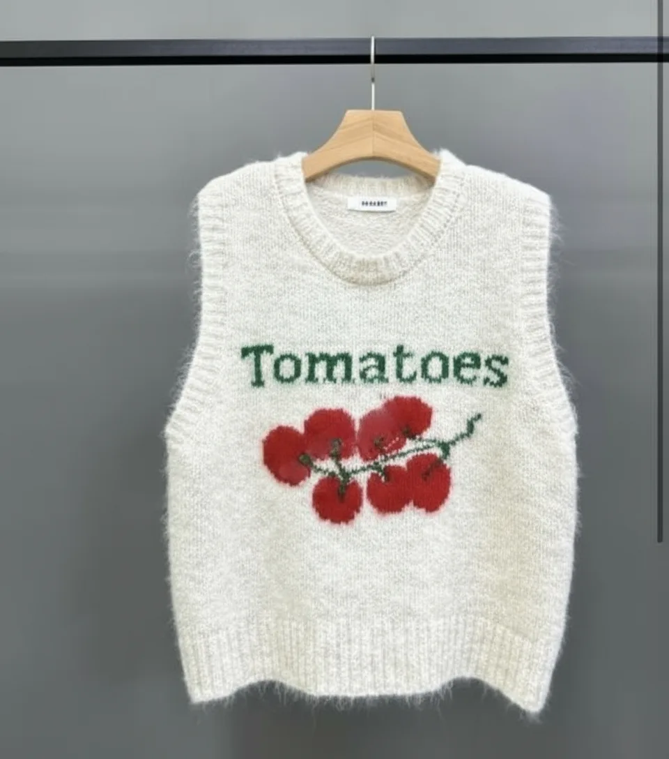 "Tomatoes" Embroidered Knit Vest "Tomatoes" Embroidered Knit Vest — A sleeveless knit vest embroidered with cherry tomatoes on the vine and the word Toma