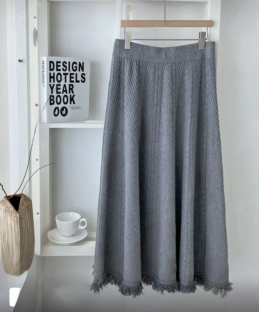 Knitted Fringe Midi Skirt — A soft knit A-line midi with a fringed hem, in creamy beige, grey or black. One size, elasti