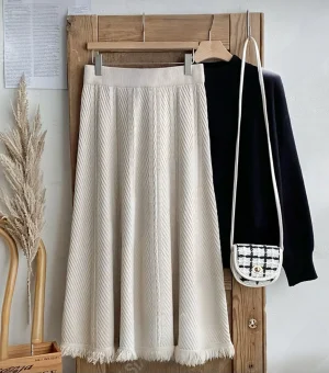 Knitted Fringe Midi Skirt — A soft knit A-line midi with a fringed hem, in creamy beige, grey or black. One size, elasti