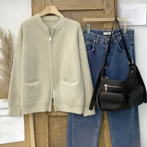 Ribbed Full-Zip Knit Cardigan — A ribbed knit cardigan with a full zip, a stand collar and two patch pockets. Black or o
