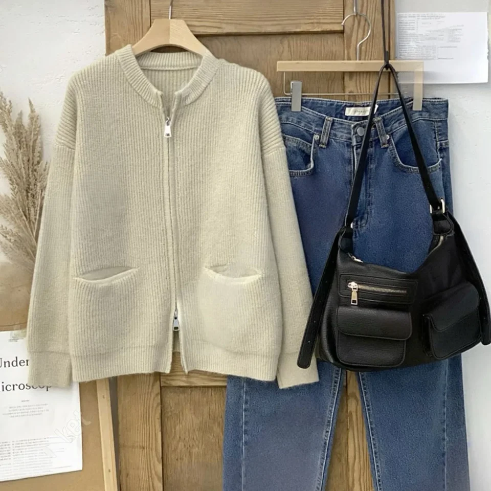 Ribbed Full-Zip Knit Cardigan — A ribbed knit cardigan with a full zip, a stand collar and two patch pockets. Black or o