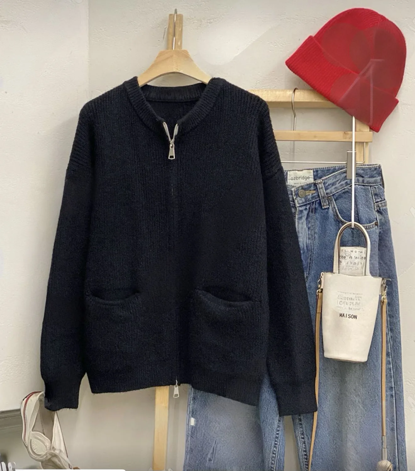 Ribbed Full-Zip Knit Cardigan Ribbed Full-Zip Knit Cardigan — A ribbed knit cardigan with a full zip, a stand collar and two patch pockets. Black or o