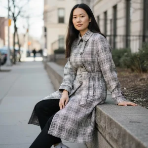 Glen Plaid Trench Coat — A black, white and pink glen plaid trench. Chest 40 inches, length 41 inches, sized L.