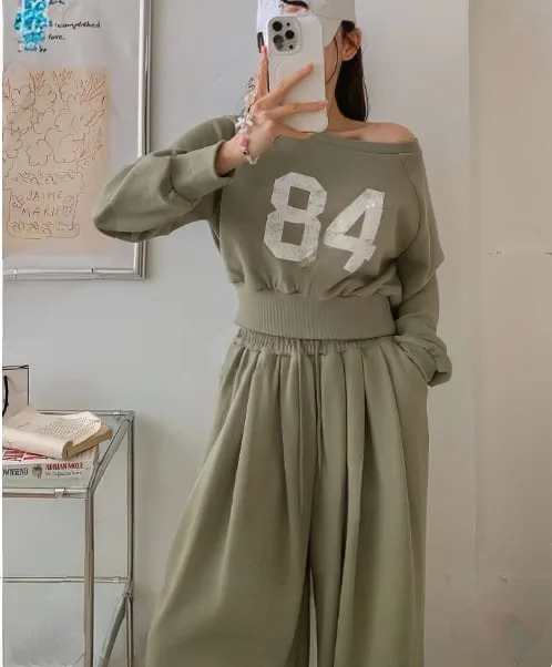 "84" Cropped Sweat Set "84" Cropped Sweat Set — A cropped 84 graphic sweatshirt with matching high-waisted wide-leg joggers. Four colours, one