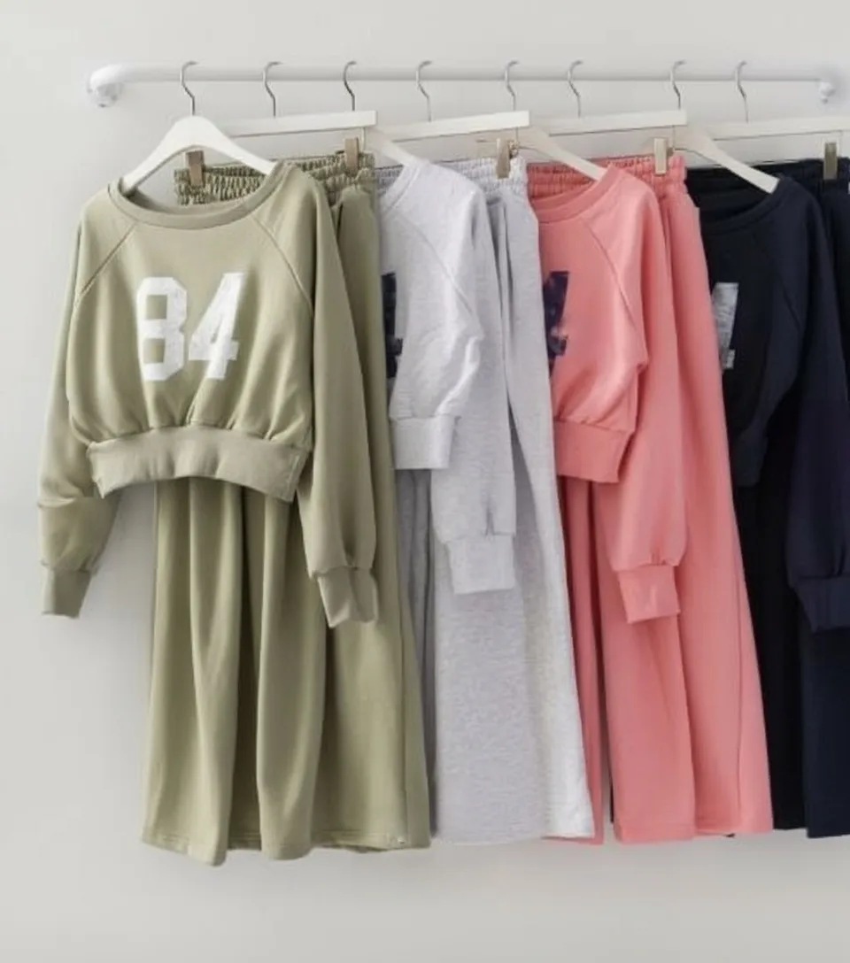 "84" Cropped Sweat Set "84" Cropped Sweat Set — A cropped 84 graphic sweatshirt with matching high-waisted wide-leg joggers. Four colours, one