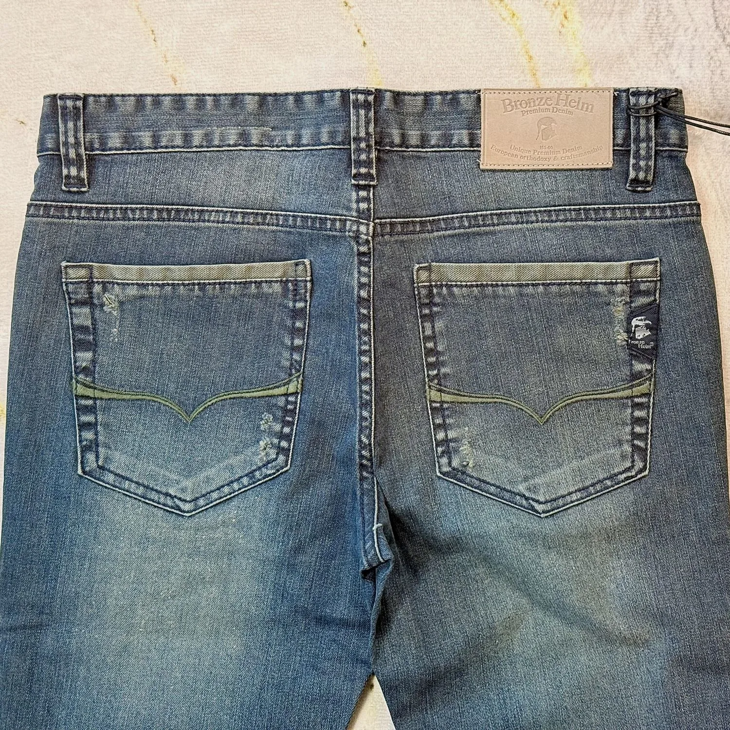 Washed Denim Jeans Washed Denim Jeans — Mid-blue washed denim in a straight cut, faded through the thigh and seat. Button fly, natural wais