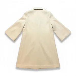 Wool-Blend Long Coat — A long, collarless wool-blend coat with a clean front and no belt. Cream, lined to the hem.