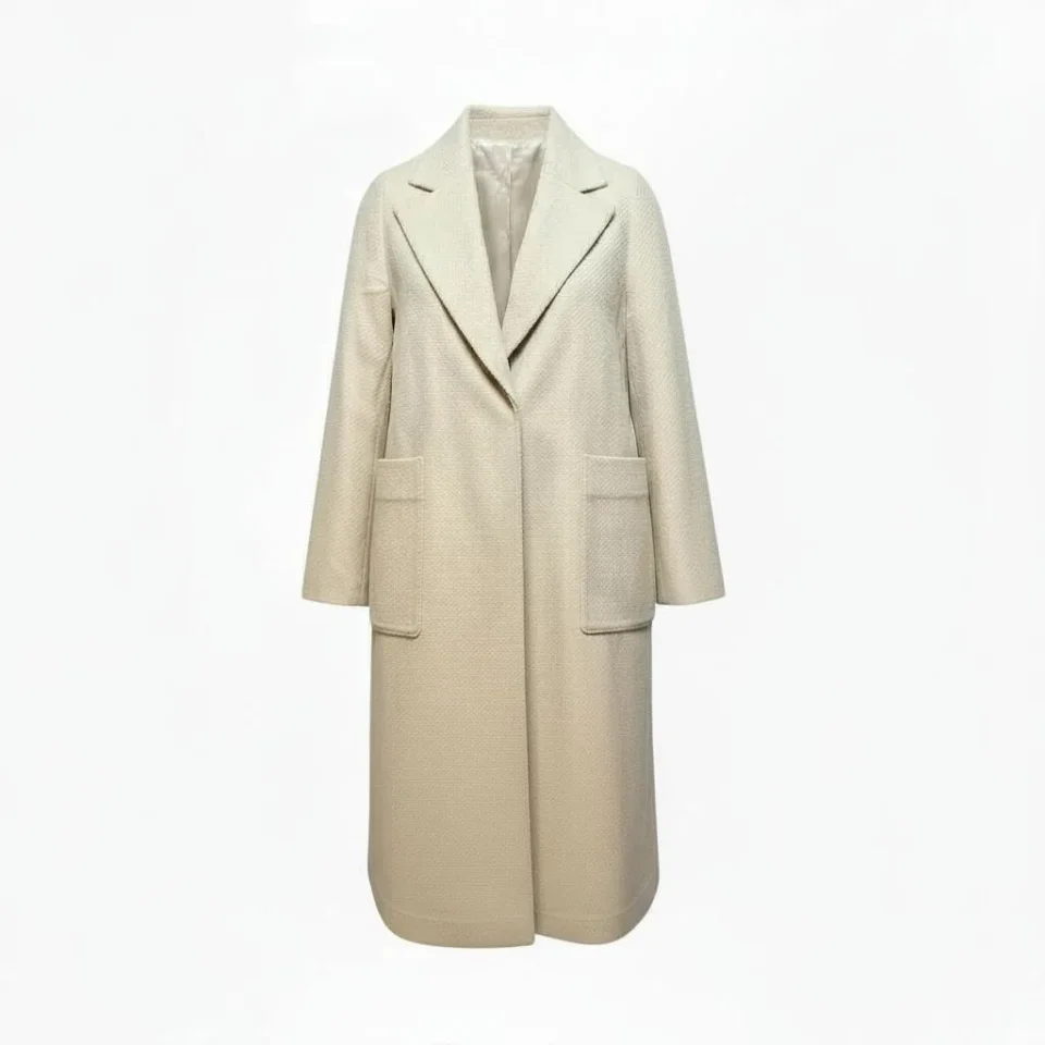 Wool-Blend Long Coat — A long, collarless wool-blend coat with a clean front and no belt. Cream, lined to the hem.